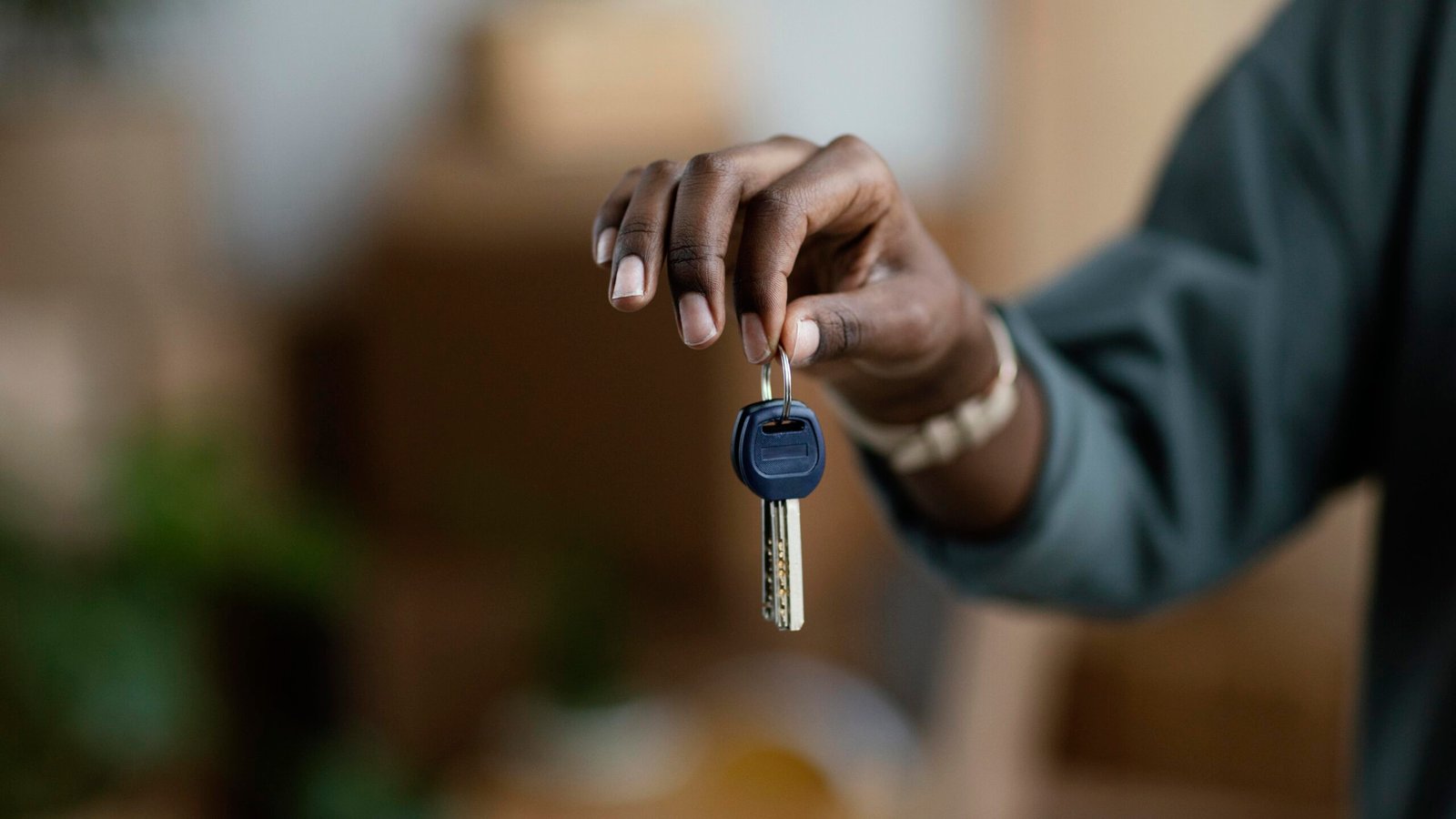 front-view-woman-holding-keys-her-new-home