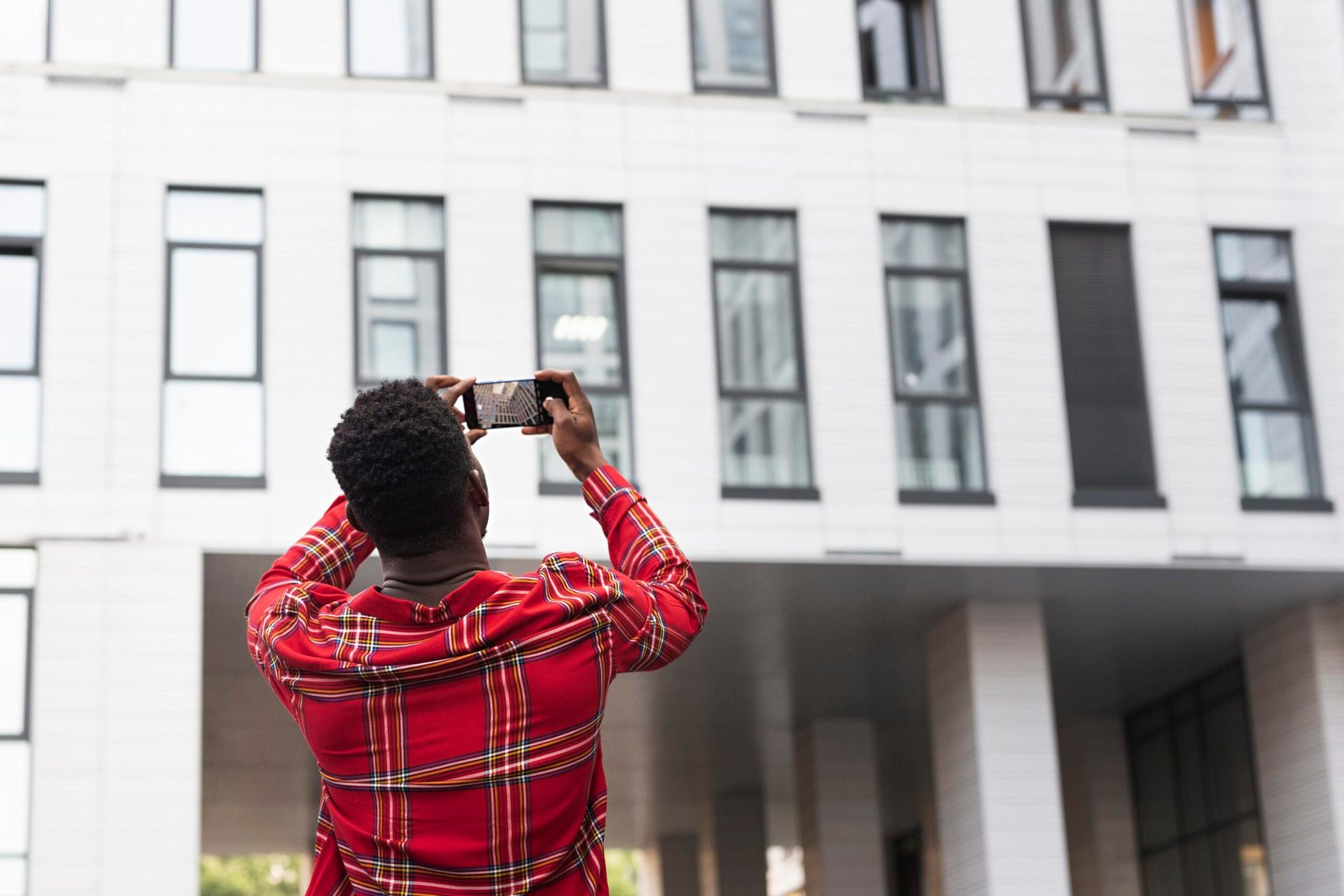 young-male-adult-taking-pictures-building